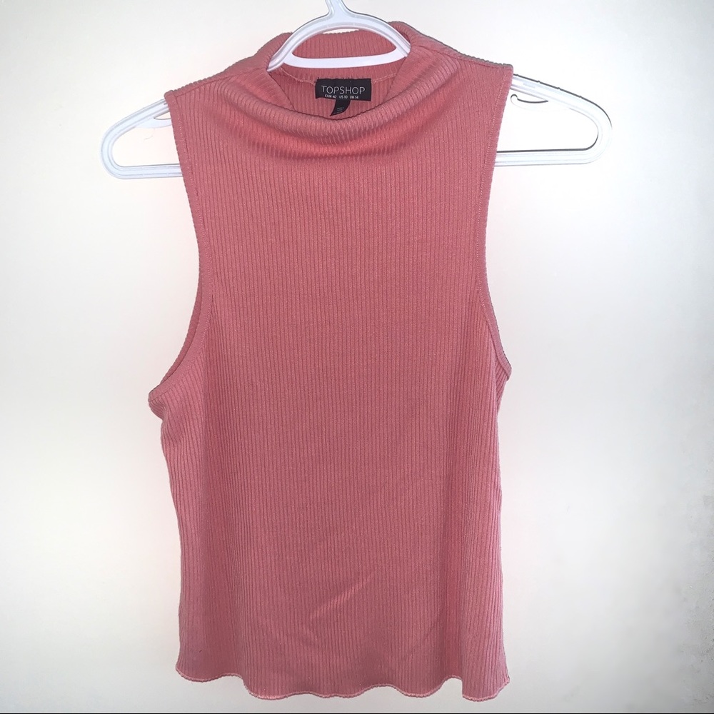Pink turtle neck shirt.